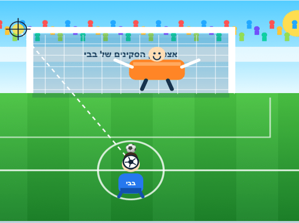 שחקן כדורגל מכוון לבעיטה לעבר השער, שמוגן על ידי דמות כתומה מחייכת. על הרשת מופיע טקסט בעברית. קו מקווקו מציין את מסלול הכדור. ברקע נראים המגרש וקהל הצופים.